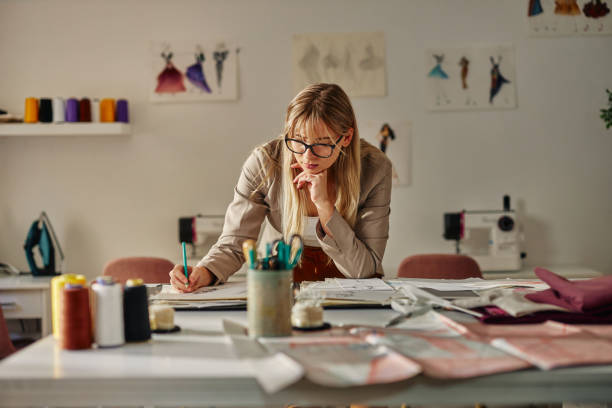 istock Female fashion designer working in office 1356831917