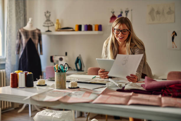 istock Small business owner with digital tablet and sketches 1356831966