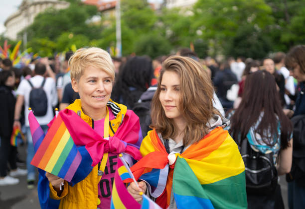 istock Two women supporting equal sexuality at pride parade 1356832112