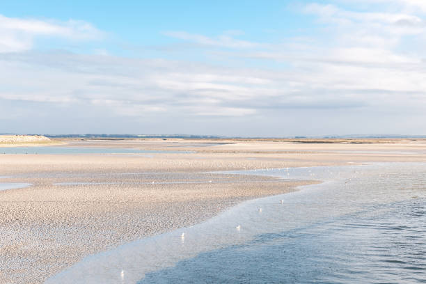 Sandy beach with the rising tide in Baie de Somme stock photo