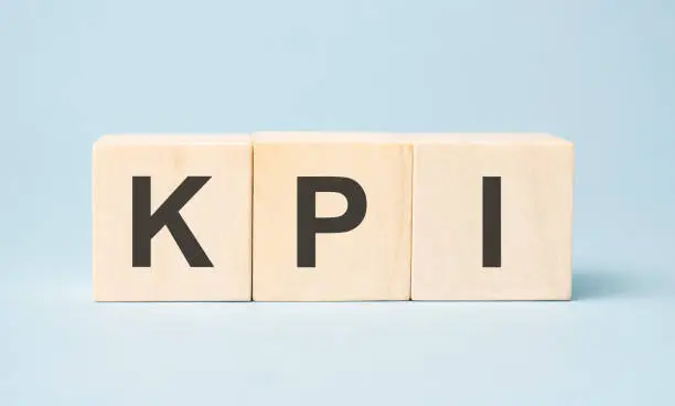 Photo of kpi word written on wooden cubes with copy space