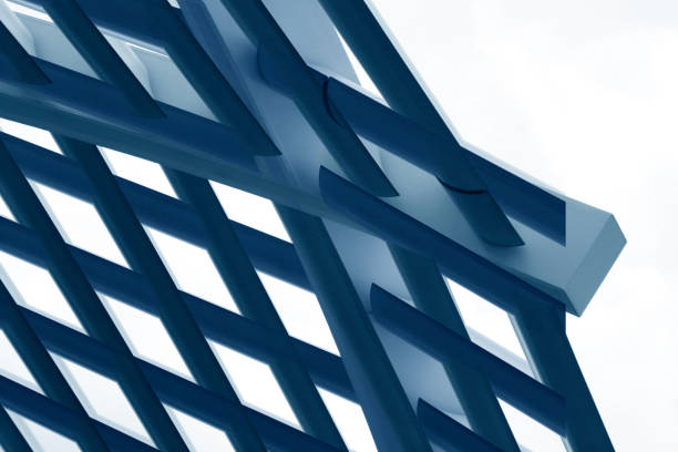 istock Close-up of technological metal grid structure. Abstract background image in shades of metallic blue color on the subject of modern architecture, industry or technology. 1356834946