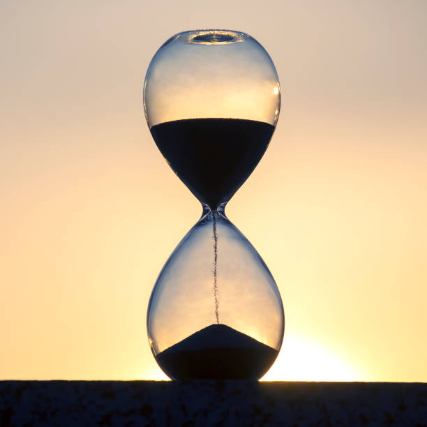 istock Hourglass against the background of the evening setting sun 1356836404