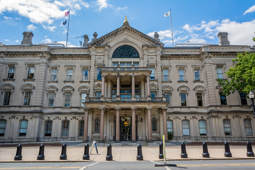 Trenton, New Jersey, United States of America - September 6, 2016. Exterior view of New Jersey State House building in Trenton, NJ. The New Jersey State House is located on the W. State Street in downtown Trenton. The Capitol is the most historic public building in New Jersey, comprised of the State Legislature, the Governor's Office and other Executive branch offices. The Capitol was originally built in 1792 and most parts were renovated in 1987.