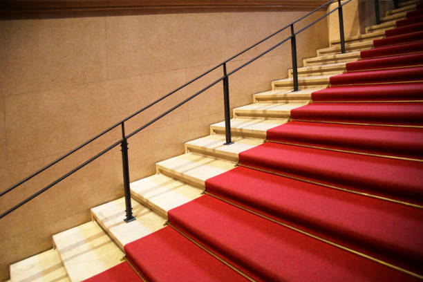 Staircase covered by red carpet runner Solemn or ceremonial architecture fragment carpet runner stock pictures, royalty-free photos & images