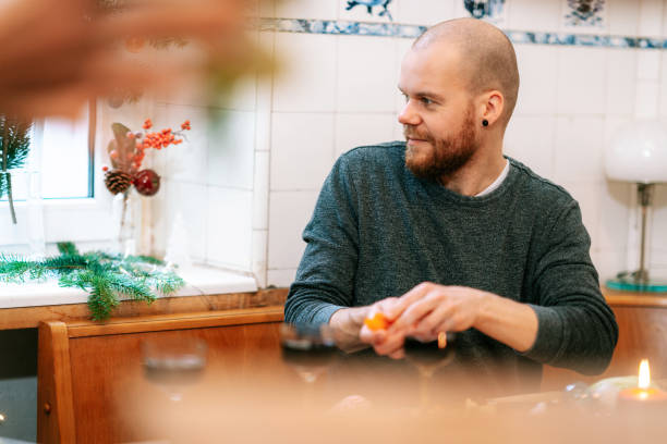 istock Man sitting at table preparing christmas meal at home 1356840567