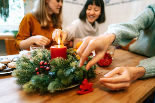 istock Hands decorating dinner table with advent wreath for Christmas eve 1356840657