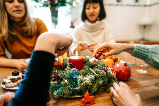 istock Close-up of women hands decorating dinner table for christmas 1356840691