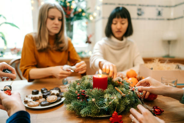 istock Group of women decorating dinner table for Christmas eve 1356840704