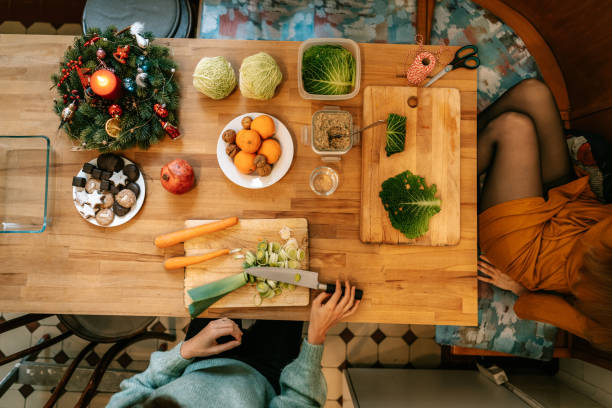 istock Females preparing vegetarian christmas meal at decorated kitchen table 1356840707