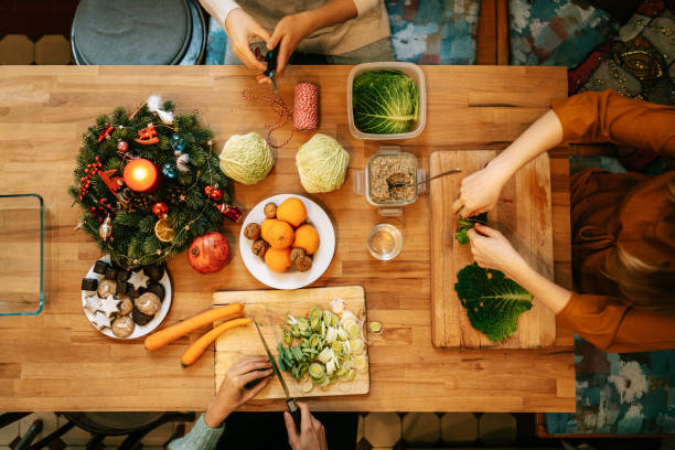 istock Women preparing christmas meal at decorated table 1356840721