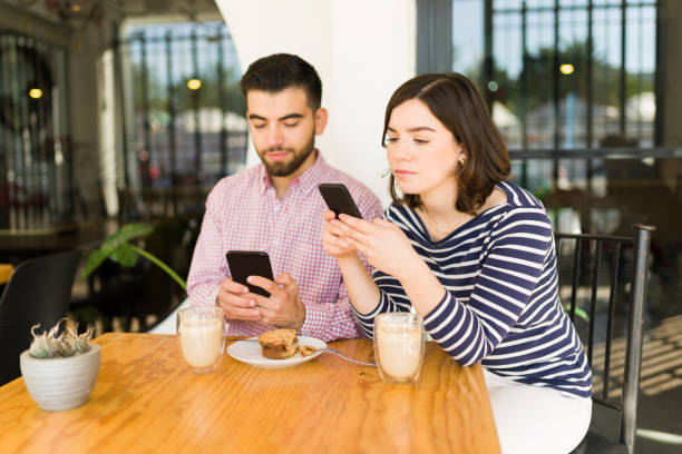 istock Tired woman and man having a failed date 1356840825