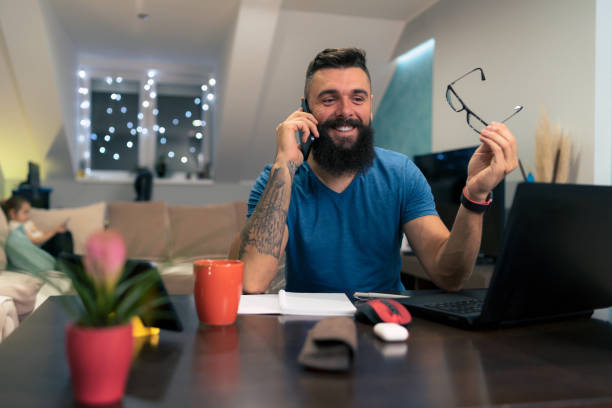 istock Young businessman working at home while using laptop and a smartphone 1356841886