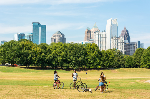 Atlanta, Georgia, United States of America - September 27, 2016. View of the the Midtown Skyline in Atlanta, GA, from the Piedmont Park, with people in the foreground.