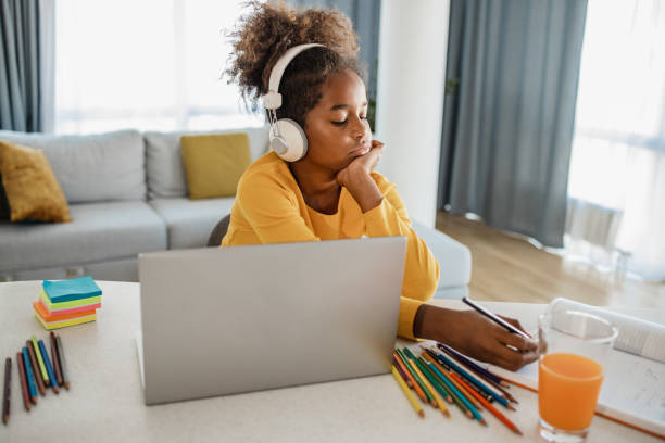 istock Girl doing homework at home 1356842737