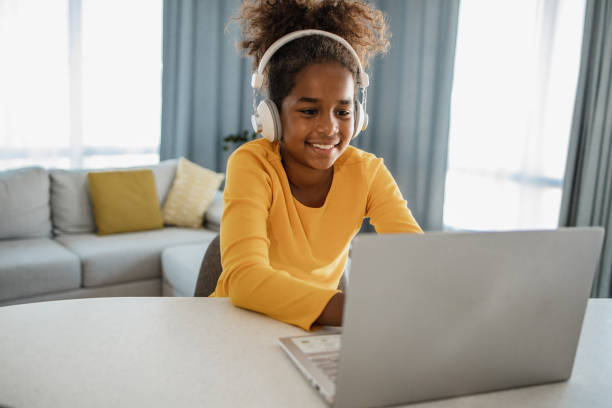 istock Young girl at home using laptop 1356842771