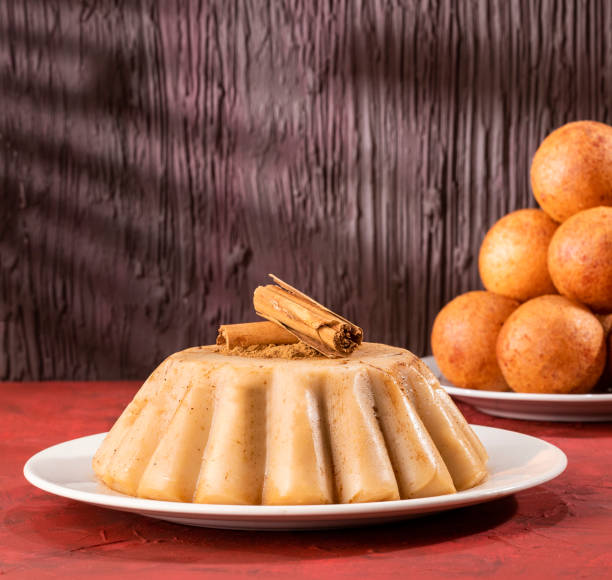 Traditional Colombian christmas food - Buñuelos and custard Buñuelo and natilla Colombian cuisine - Christmas tradition custard photos stock pictures, royalty-free photos & images