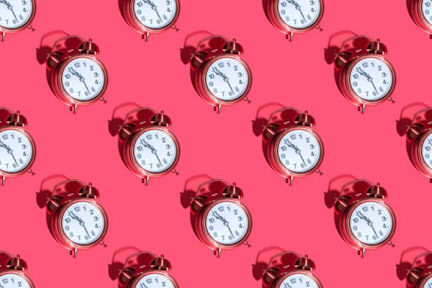 istock Alarm clock on a colored background hard shadows. Close up. Seamless patterns 1356844205