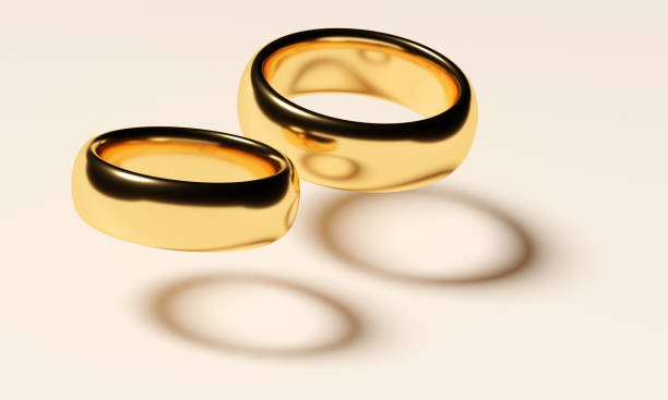 istock Two wedding gold rings fly. Love concept 1356845316