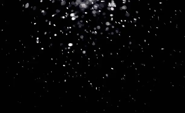 Photo of texture of falling snow, layer to overlay on a black background