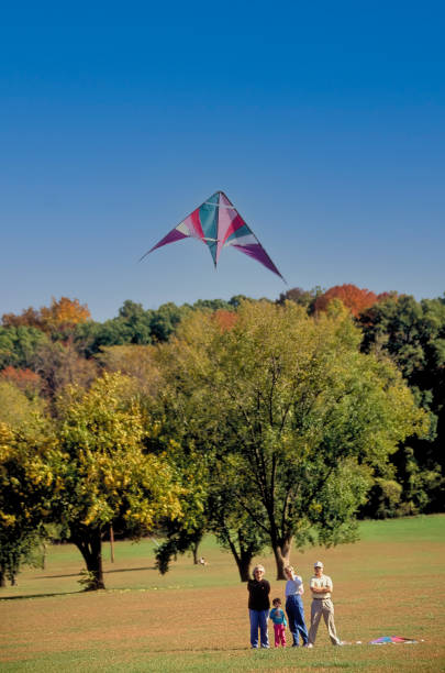 Springfield, Missouri USA October 9, 1992: A family flies a kite in one of Springfield, Missouri's parks in early October 1992.