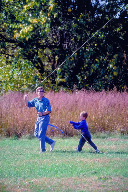 Father and Son Flying a Kite with Copy Space stock photo