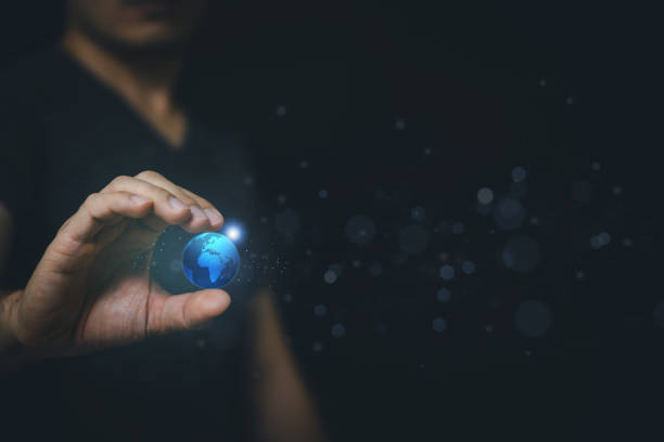istock Human hand holding earth globe holographic technology . 1356860342