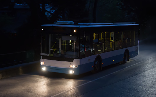 bus moves on a night road in summer