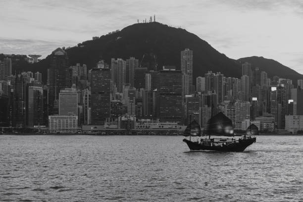 istock Hong Kong City skyline with junk boat 1356865799