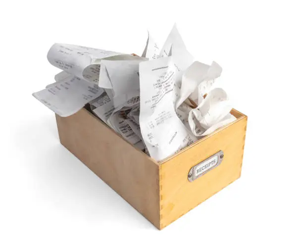 Photo of Overfilled box of receipts for filing taxes and deductibles.