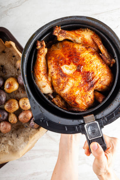 A whole chicken cooked inside an air frier concept stock photo
