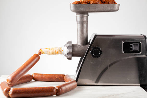 Close up isolated image of homemade sucuk or Sausage that is being stuffed into casing using electrical stuffer device stock photo
