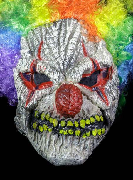 istock Clown Mask with Wig Isolated Against Black Background 1356872768