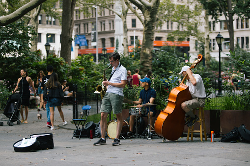 Manhattan, NY, USA - August 28, 2021:  People enjoy a warm summer day in Madison square park.