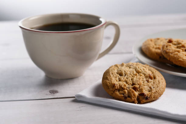 istock Nut cookies and a coffee cup on a gray wooden table. 1356873625