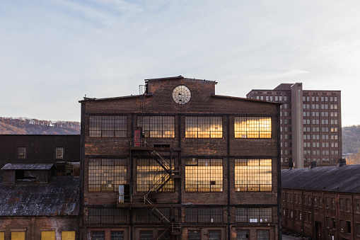 Sunlight beams through the rusty structure of the Steelstacks, an abandoned steel factory in Bethlehem, Pennsylvania. The intricate ironwork and the grand scale of the industrial age, now silent and still, set against a clear sky at sunset