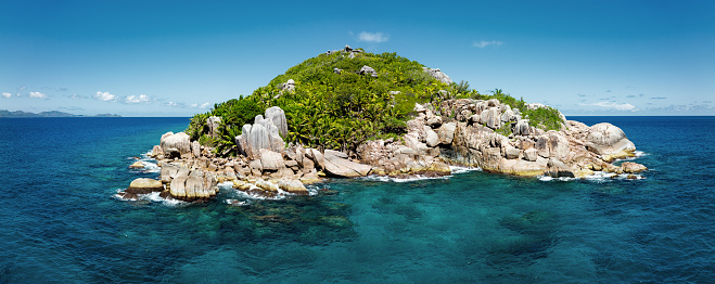 Petite Soeur Island Panorama. Drone Point of view over the small Petite Soeur Islet next to Grande Soeur Islet and La Digue Island. Stitched XXL Drone Point of View Full Island Panorama. Petite Soeur Island is a beautiful diving and snorkeling islet close to the bigger and famous La Digue Island, Seychelles Islands, East Africa