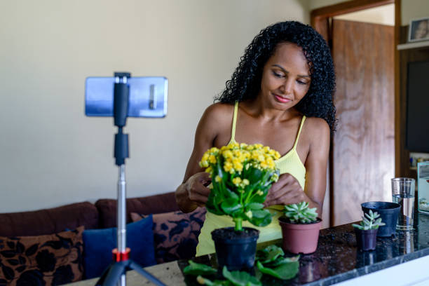 istock Woman watching video lesson for decorating plant care 1356887828