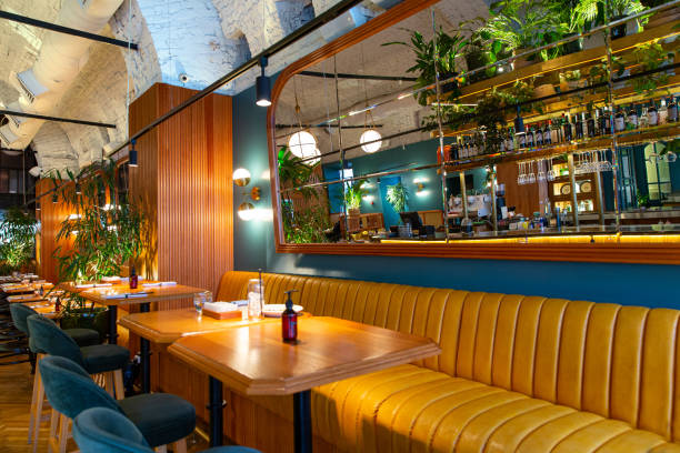 Interior of modern loft style restaurant with fresh flowers and mirror