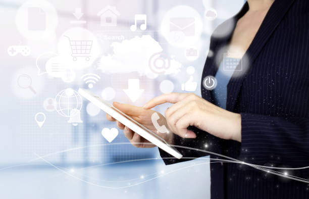 istock Social media concept. Communication network. Hand touch white tablet with digital hologram social media icons sign on light blurred background. Communication and network concept. 1356894265