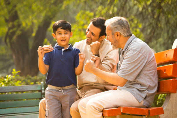 istock Three generation family celebrating success at park 1356894497