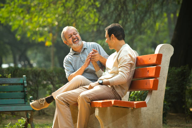 istock Old man spending leisure time with son at park 1356894625