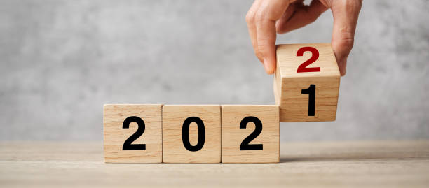 istock hand flipping block 2021 to 2022 text on table. Resolution, strategy, plan, goal, motivation, reboot, business and New Year holiday concepts 1356895664