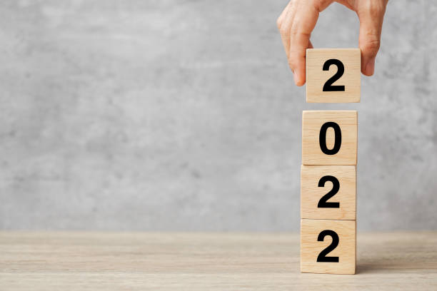 istock hand holding block 2022 text on table. Resolution, strategy, plan, goal, motivation, reboot, business and New Year holiday concepts 1356895685