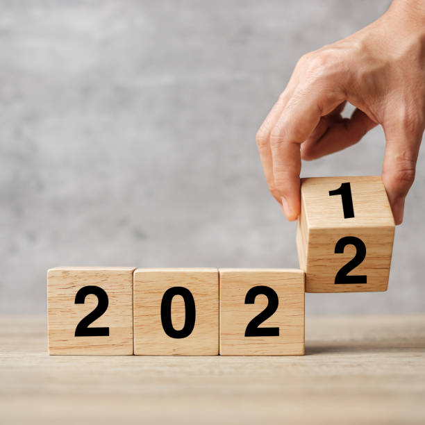 istock hand flipping block 2021 to 2022 text on table. Resolution, strategy, plan, goal, motivation, reboot, business and New Year holiday concepts 1356895716