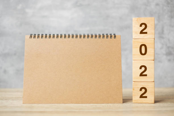 istock 2022 Happy New Year with blank notebook and wooden number. countdown, Resolution, Goals, Plan, Action and Mission Concept 1356896384