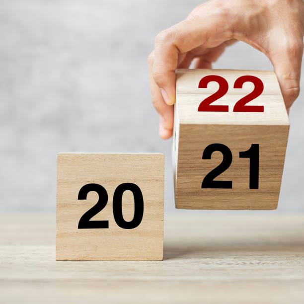 istock hand flipping block 2021 to 2022 text on table. Resolution, strategy, plan, goal, motivation, reboot, business and New Year holiday concepts 1356896555