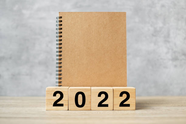 istock 2022 Happy New Year with blank notebook and wooden number. countdown, Resolution, Goals, Plan, Action and Mission Concept 1356896567