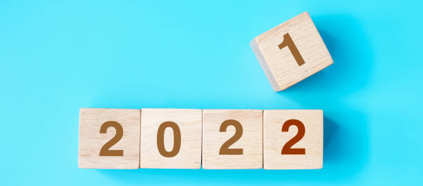 istock 2022 wooden cube blocks on blue background. Resolution, plan, review, goal, start and New Year holiday concepts 1356896739