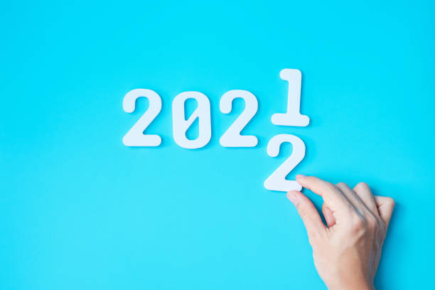istock hand change 2021 to 2022 number on blue background. Plan, finance, Resolution, strategy, solution, goal, business and New Year holiday concepts 1356896741